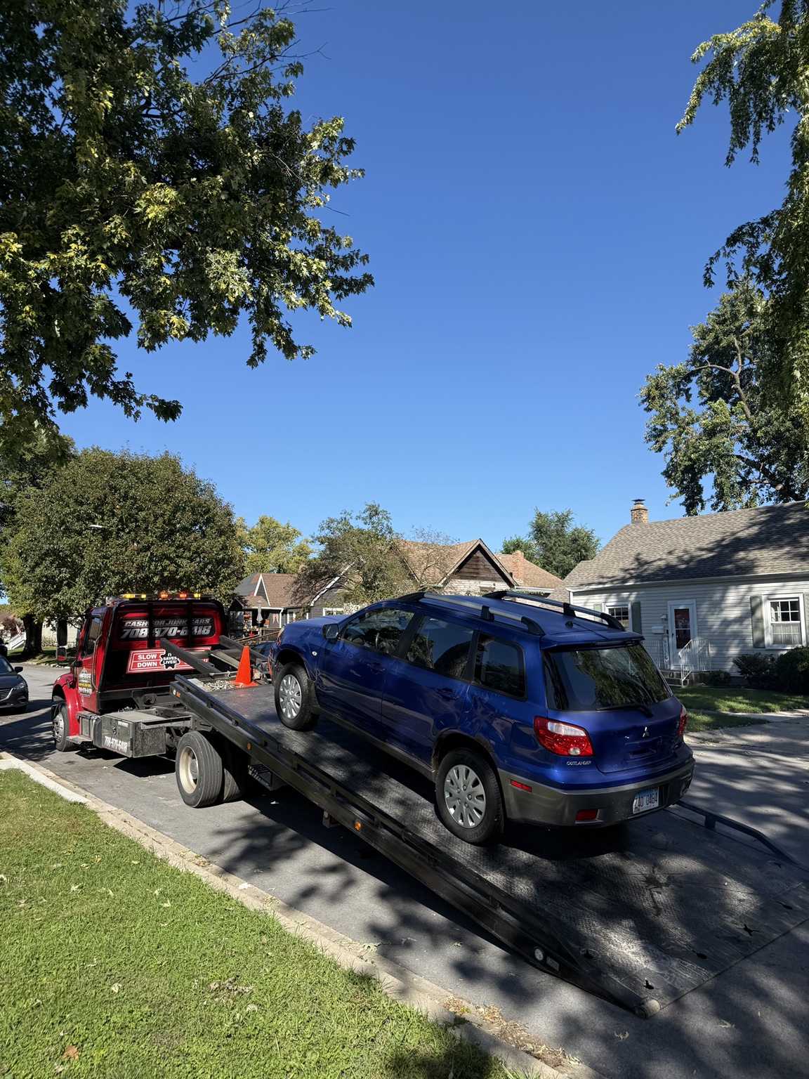 Blue Mitsubishi Outlander being loaded onto the flatbed